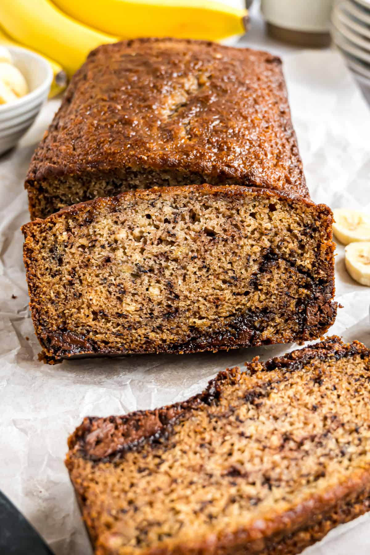 Loaf of banana bread sliced to reveal nutella swirls.