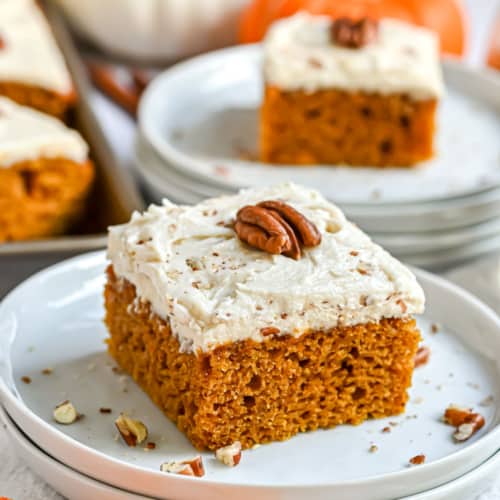 The most perfect Pumpkin Bars with a sweet Butter Pecan Frosting. These frosted pumpkin bars will seriously make you swoon! Share a pan with friends and family this holiday season!
