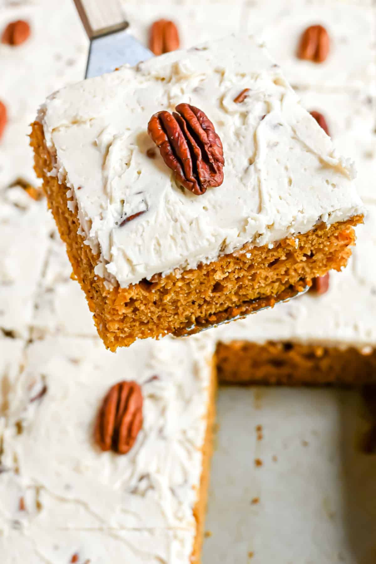 Pumpkin bar being lifted out of pan with a spatula.