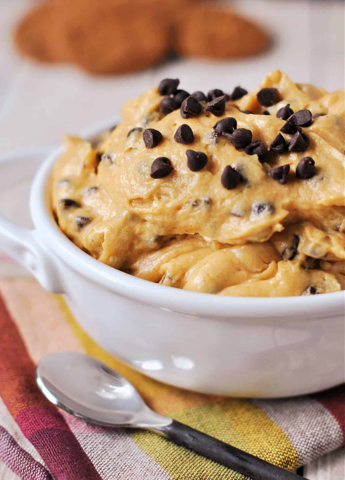 Pumpkin dip with chocolate chips in a white bowl.