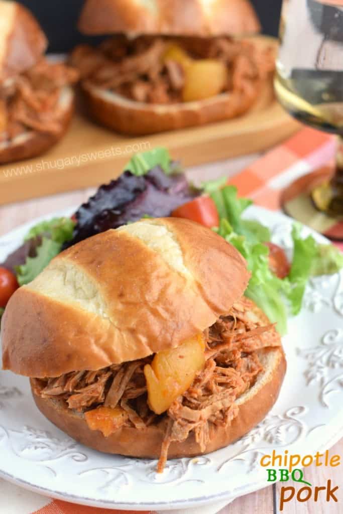 Slow Cooker Chipotle BBQ Pork recipe: delicious tangy pork with sweet peaches on a pretzel bun!