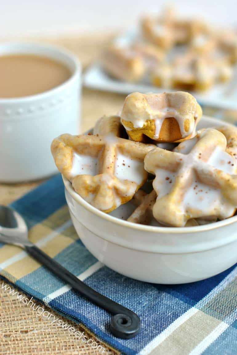 Pumpkin spice waffles in a white bowl with glaze.