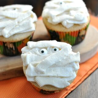 Vanilla bean cupcakes with vanilla frosting decorated for Halloween.