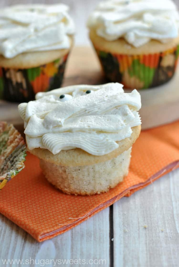 Vanilla bean cupcake unwrapped so you can see the flecks of vanilla bean.