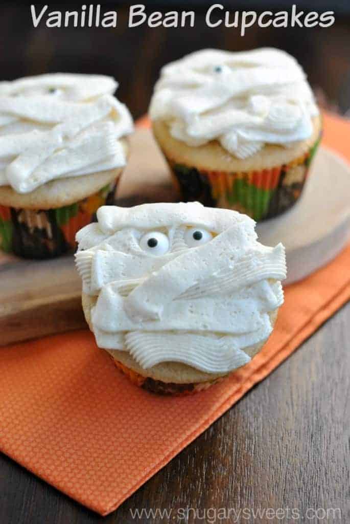 Wanilla cupcakes with a vanilla bean frosting in shape of mummies for Halloween.