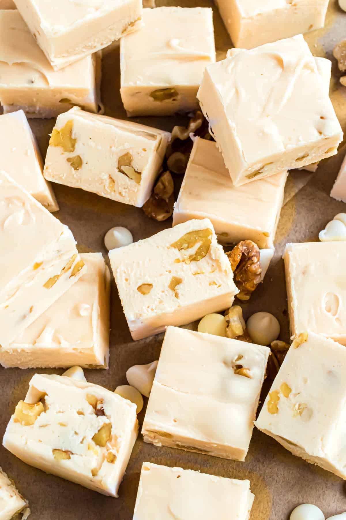 Pieces of maple walnut fudge on parchment paper.