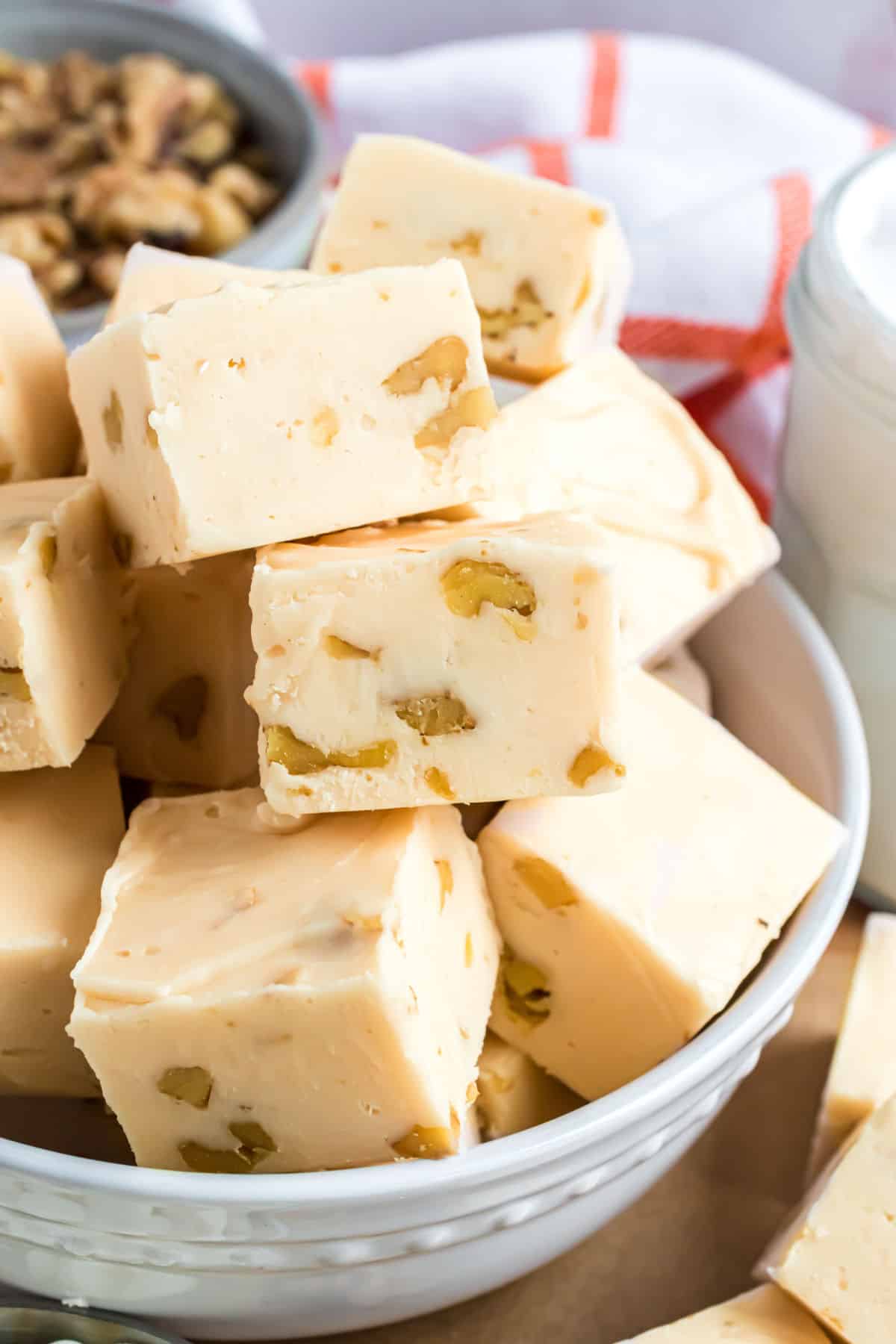 Maple walnut fudge served in a white bowl.