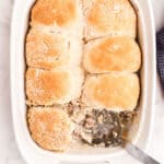 Sausage gravy casserole in 13x9 baking dish withs scoop removed.