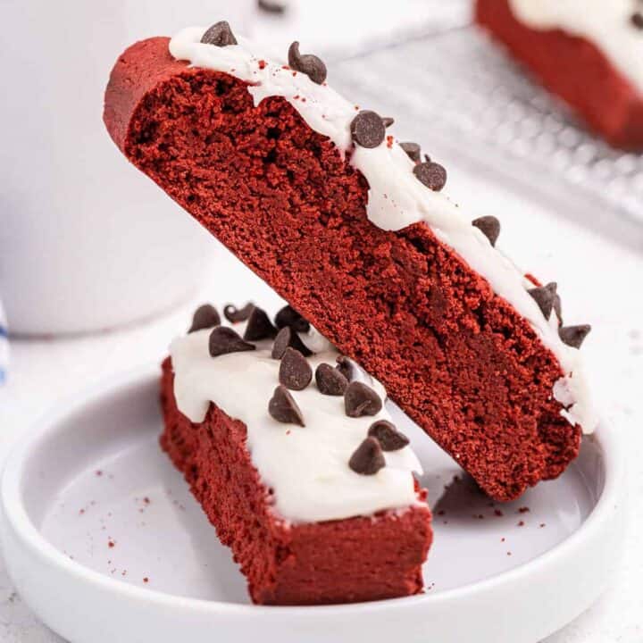 Love coffee and biscotti? This Red Velvet Biscotti with the hint of chocolate is perfection. Pair it with your favorite blend of freshly brewed coffee for a sweet pick-me-up! We spread on some cream cheese icing and sprinkled with chocolate chips!