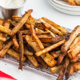 Looking for a snack idea, a shareable appetizer or a fun side dish? These Baked French Fries are calling your name. Crispy baked fries seasoned with a unique blend of sweet and salty mix and served with a creamy bleu cheese dressing. These fries are baked up crispy without the mess of deep frying.