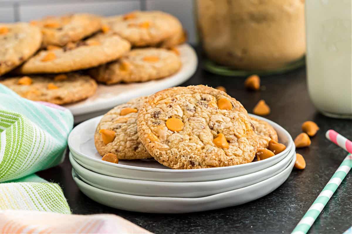 Butterscotch cookies stacked on white plates.