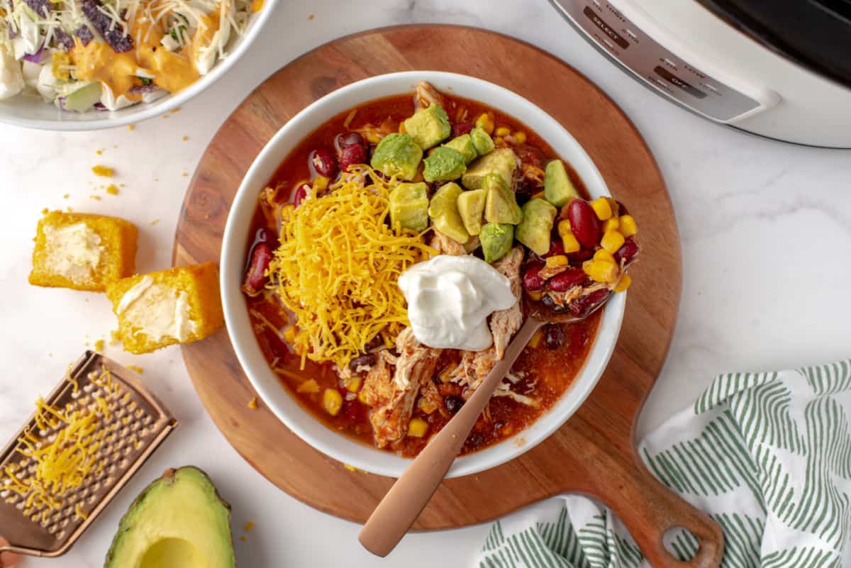 Taco chili with chicken in a bowl with garnishes.