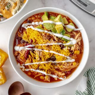 Slow Cooker Chicken Taco Chili is the answer to "what's for dinner?" With an abundance of tex mex spices and tender chicken, this tasty chili is going to be hit in your home. I know it!