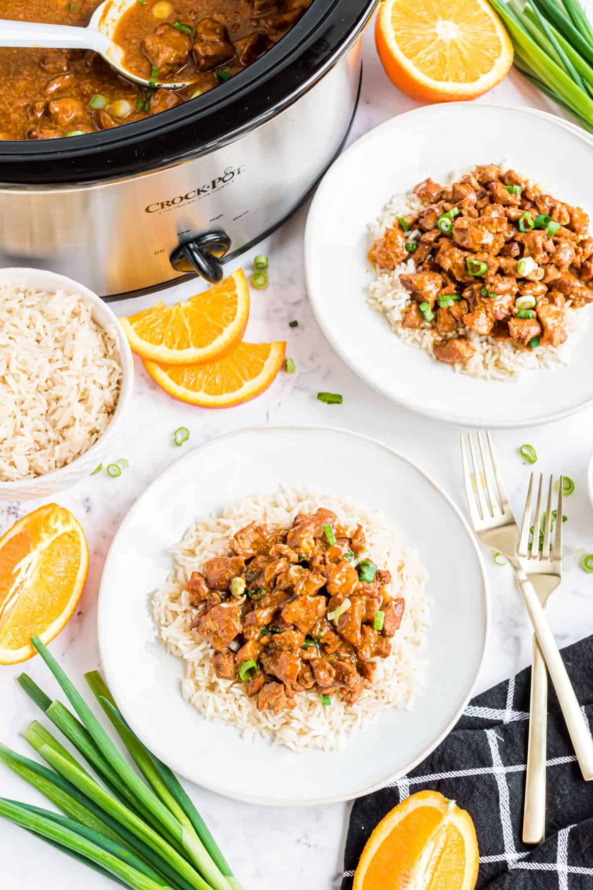 Orange chicken served on plates of rice.