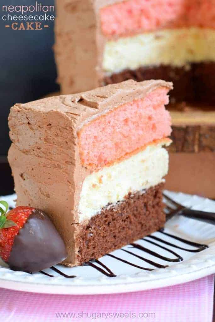 Neapolitan Cheesecake Cake: a layer of chocolate cake and a layer of strawberry cake with a cheesecake center. All wrapped in a fluffy chocolate buttercream frosting!