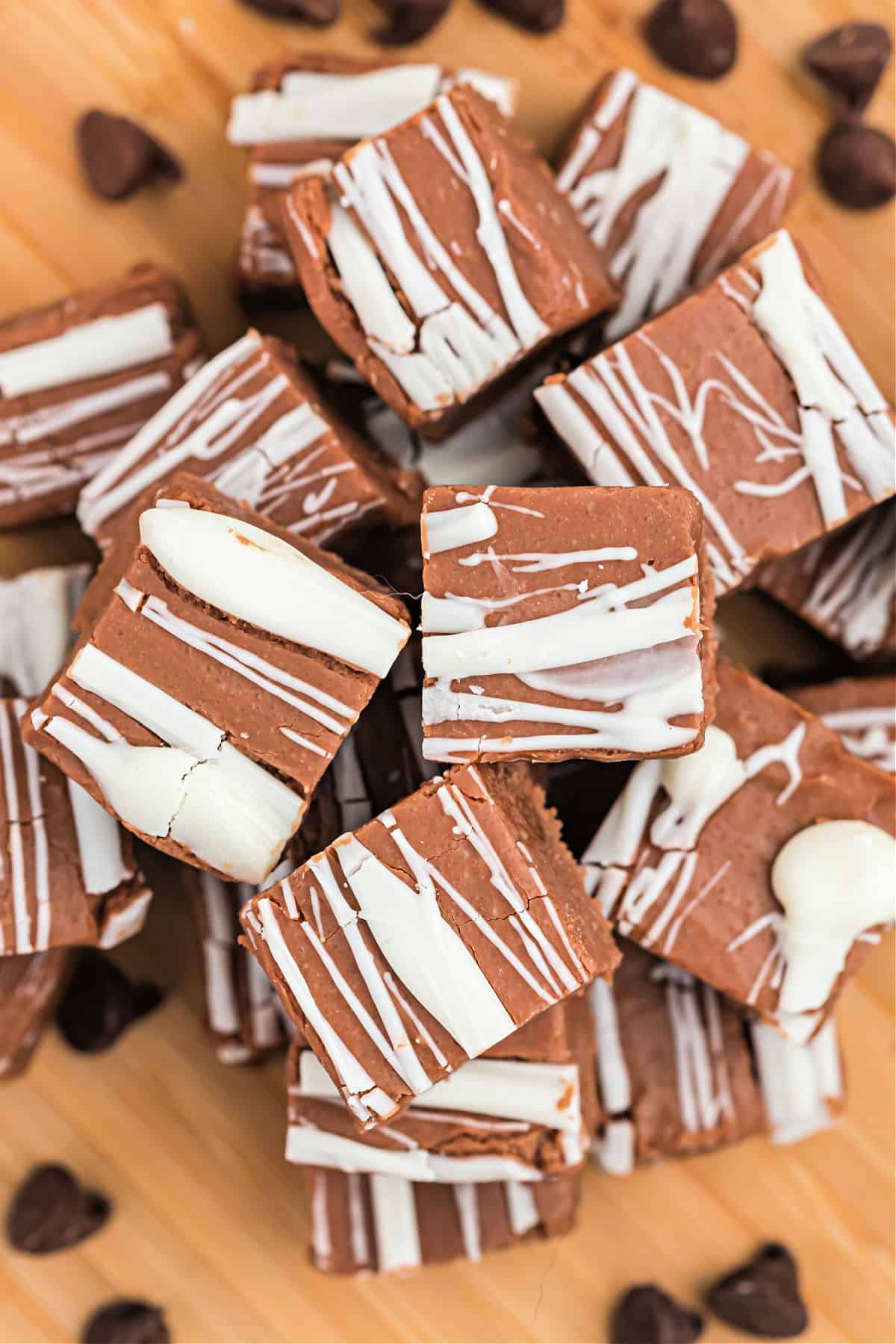 Irish cream fudge drizzle with white chocolate on a wooden platter.