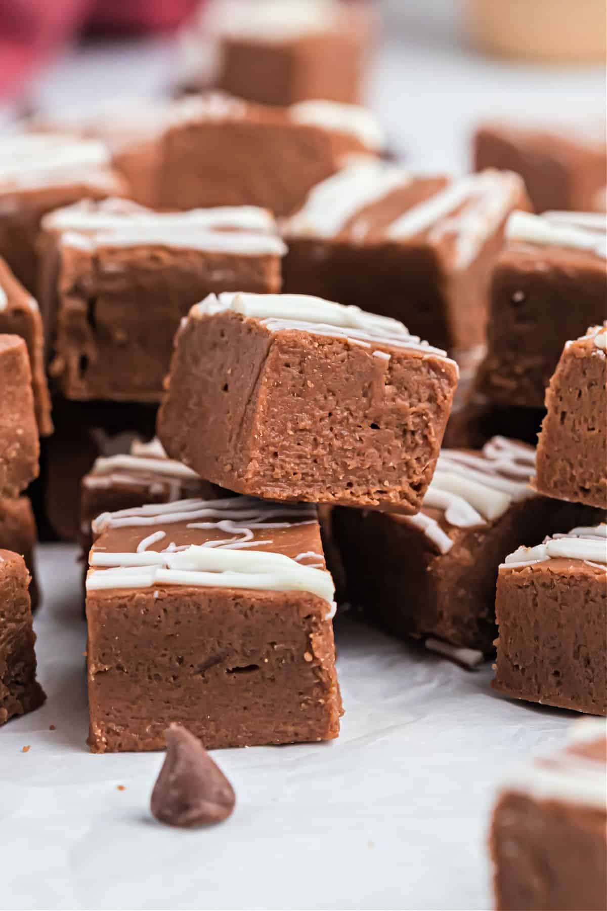 Irish cream fudge stacked on parchment paper.