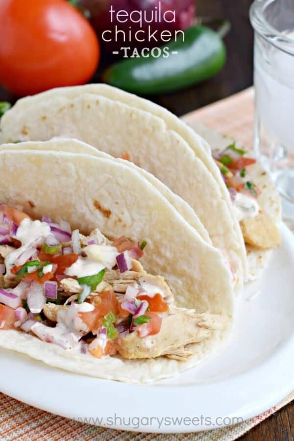 These Tequila Chicken Tacos are made in the slow cooker and topped with fresh pico de gallo and jalapeno cream!