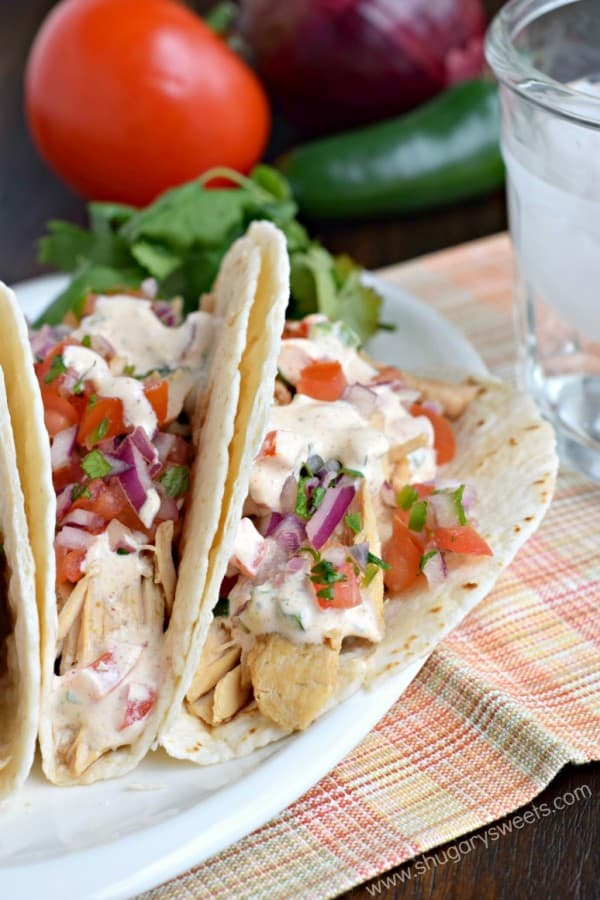 These Tequila Chicken Tacos are made in the slow cooker and topped with fresh pico de gallo and jalapeno cream!