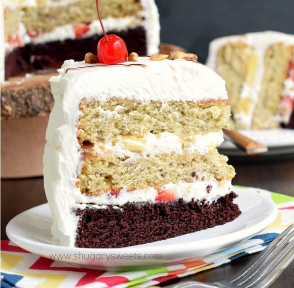 Banana Split Cake: layers of chocolate cake, banana cake, fresh fruit and whipped cream frosting for an ultimate, decadent cake recipe!