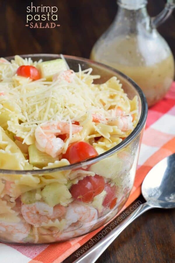 Bowtie pasta in a bowl with shrimp, vegetables and italian dressing.