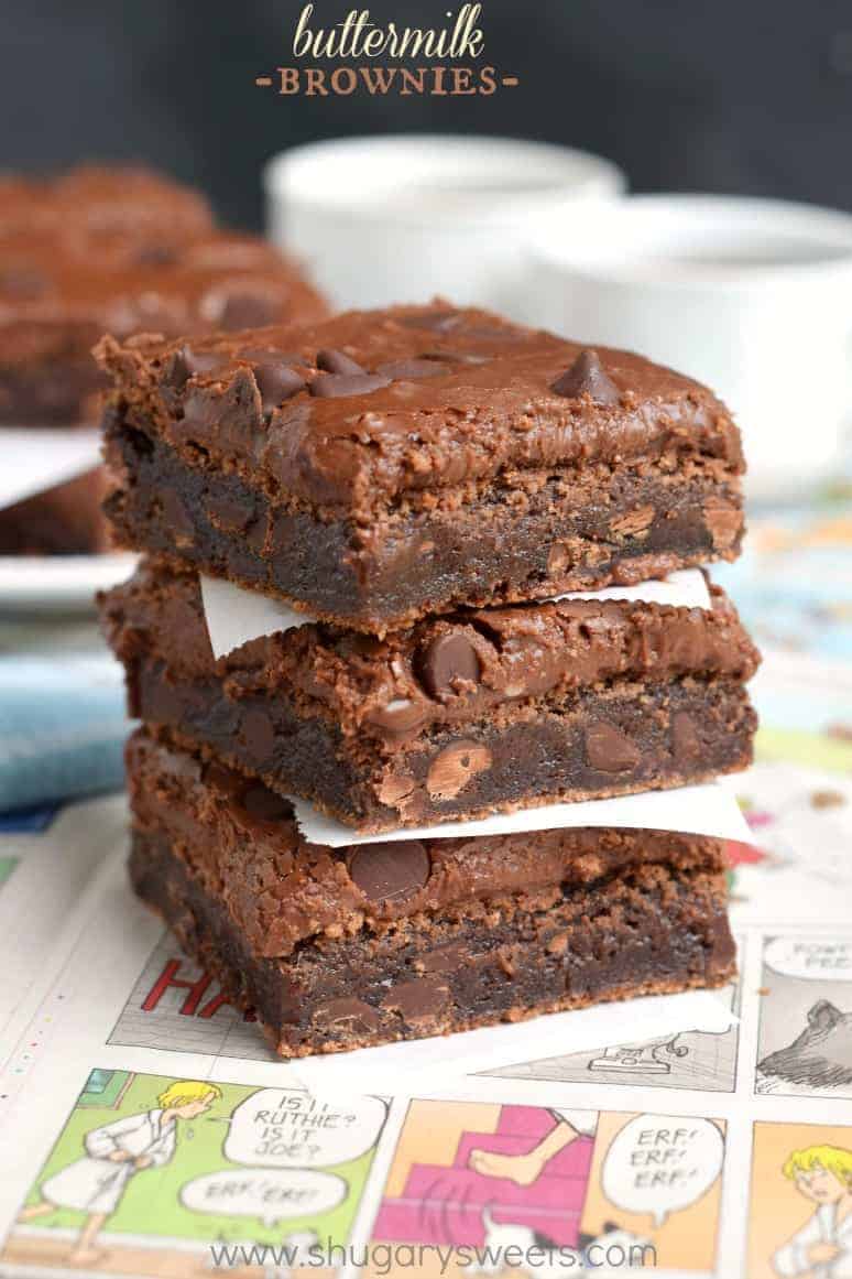 Stack of three buttermilk brownies with chocolate chips on a comic strip newspaper.