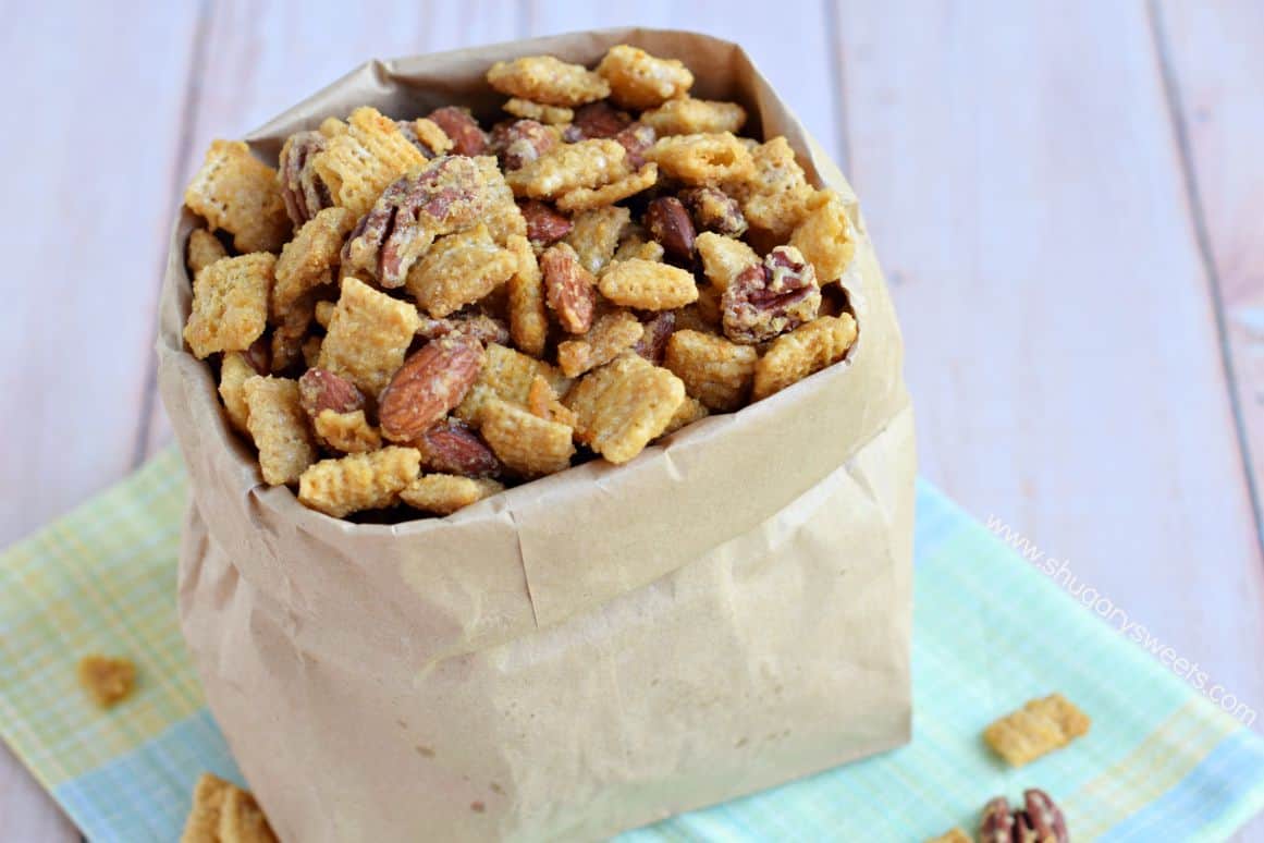 Caramel snack mix with nuts in a paper bag.