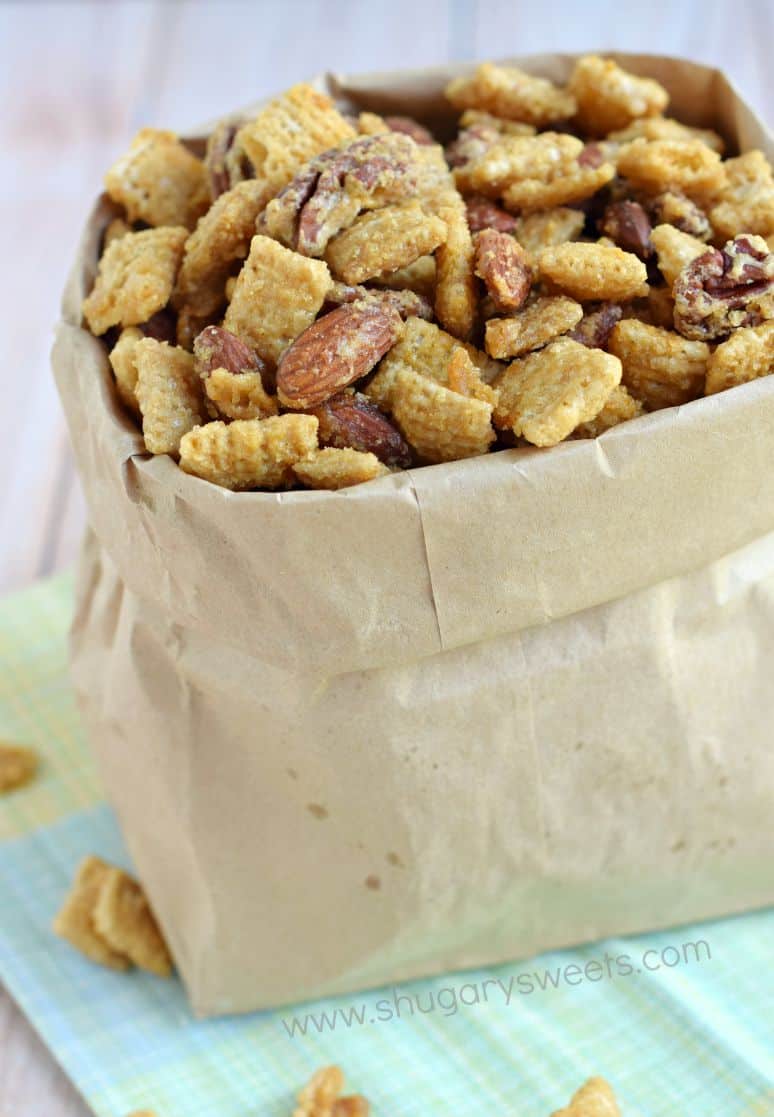 Caramel and nut snack mix in a paper bag.