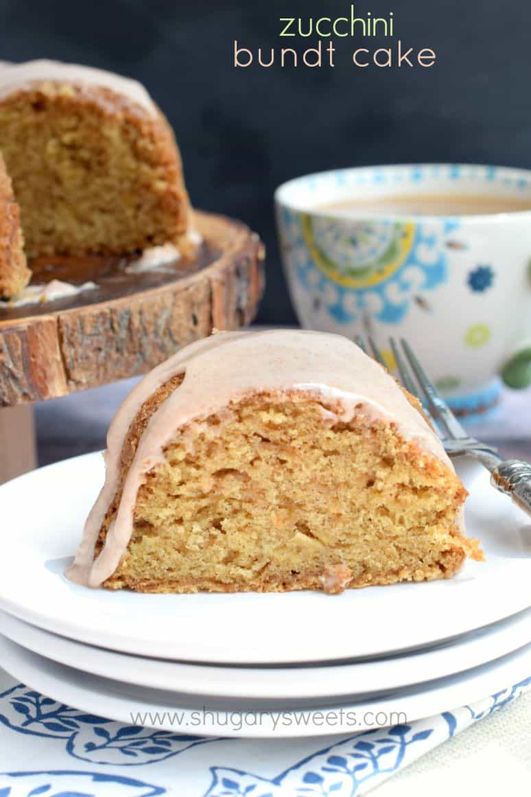 Slice of zucchini cake with cinnamon glaze on white plates.