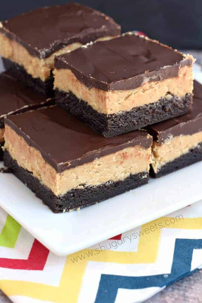 Stack of buckeye brownies on a white plate.