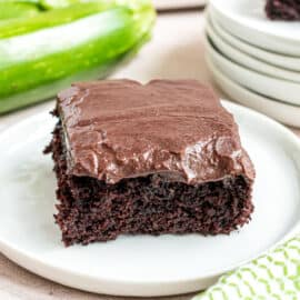 Slice of chocolate brownie with chocolate frosting.