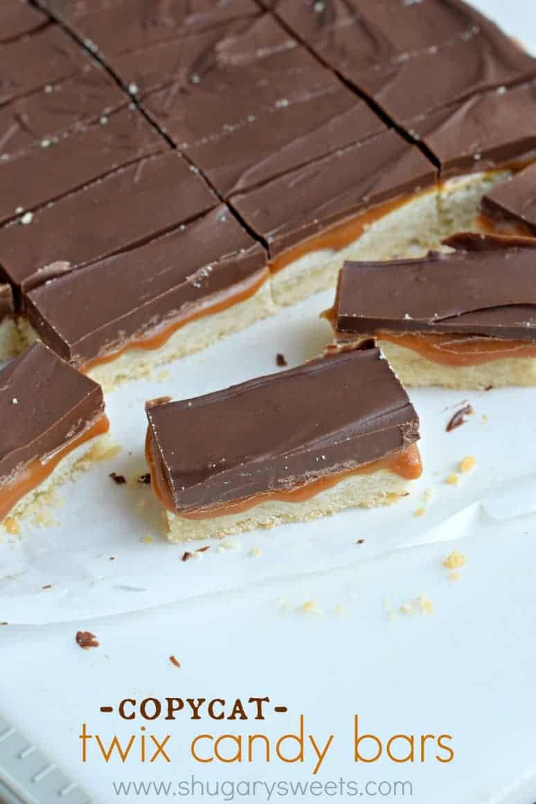 Pan of twix bars on parchment paper cut into bars.