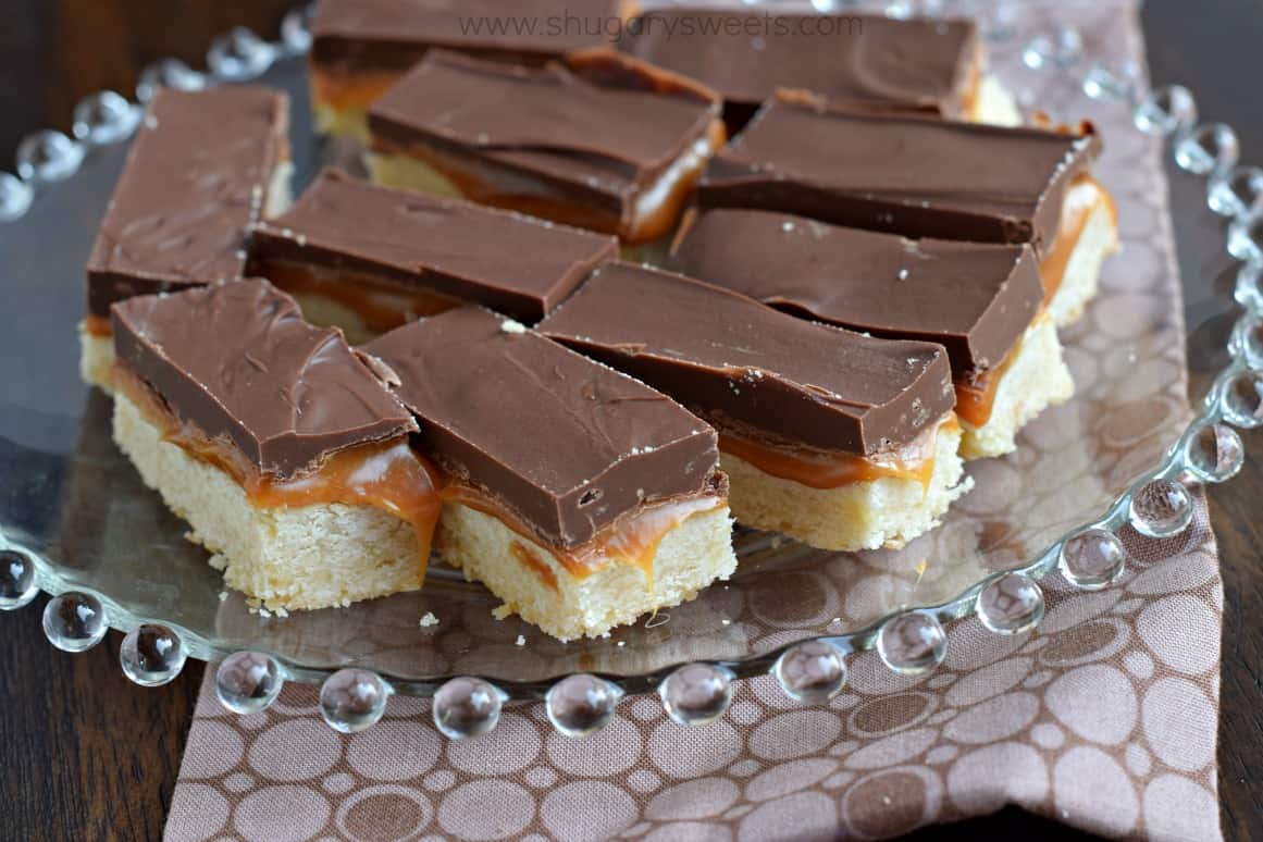 Twix cookie bars on a glass plate.