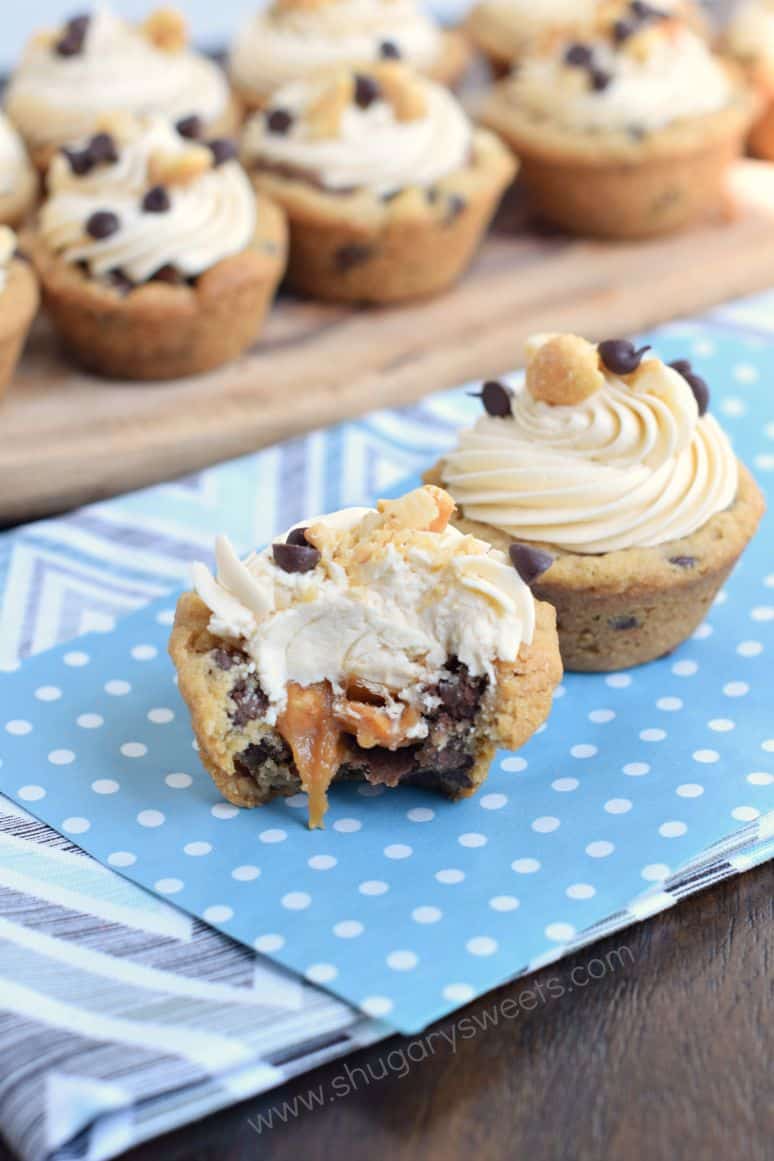 These easy and delicious Snickers Cookie Cups start with refrigerated cookie dough and candy bars. Topped with a sweet caramel frosting, they are sure to be a hit!