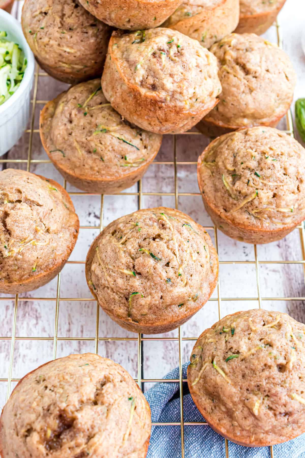 Zucchini muffins on a wire cooling rack after baking.