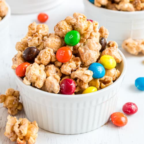 Snack time just got tastier with this homemade Peanut Butter Caramel Corn that's salty and sweet and has peanut butter M&Ms folded in! Make a batch today!