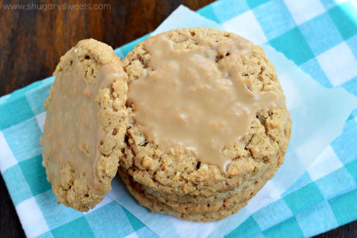 Oatmeal cookies with maple icing on blue checkered napkin.