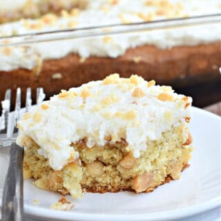 Slice of banana macadamia nut cake with one bite removed.