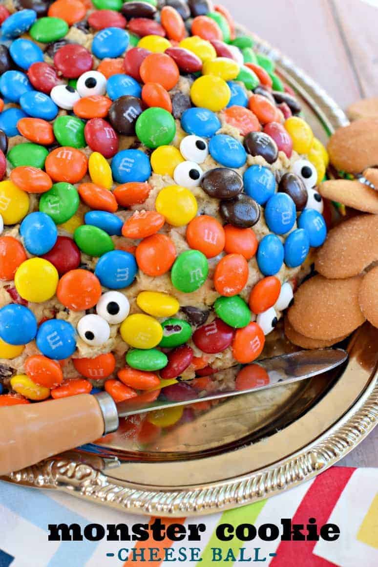 This Monster Cookie Cheese Ball recipe is a crowd pleaser! Stuffed with candy, chocolate and peanut butter, you're going to want to try this soon! Sweet monster cookie cheeseball covered in m&m candies and candy eyes.