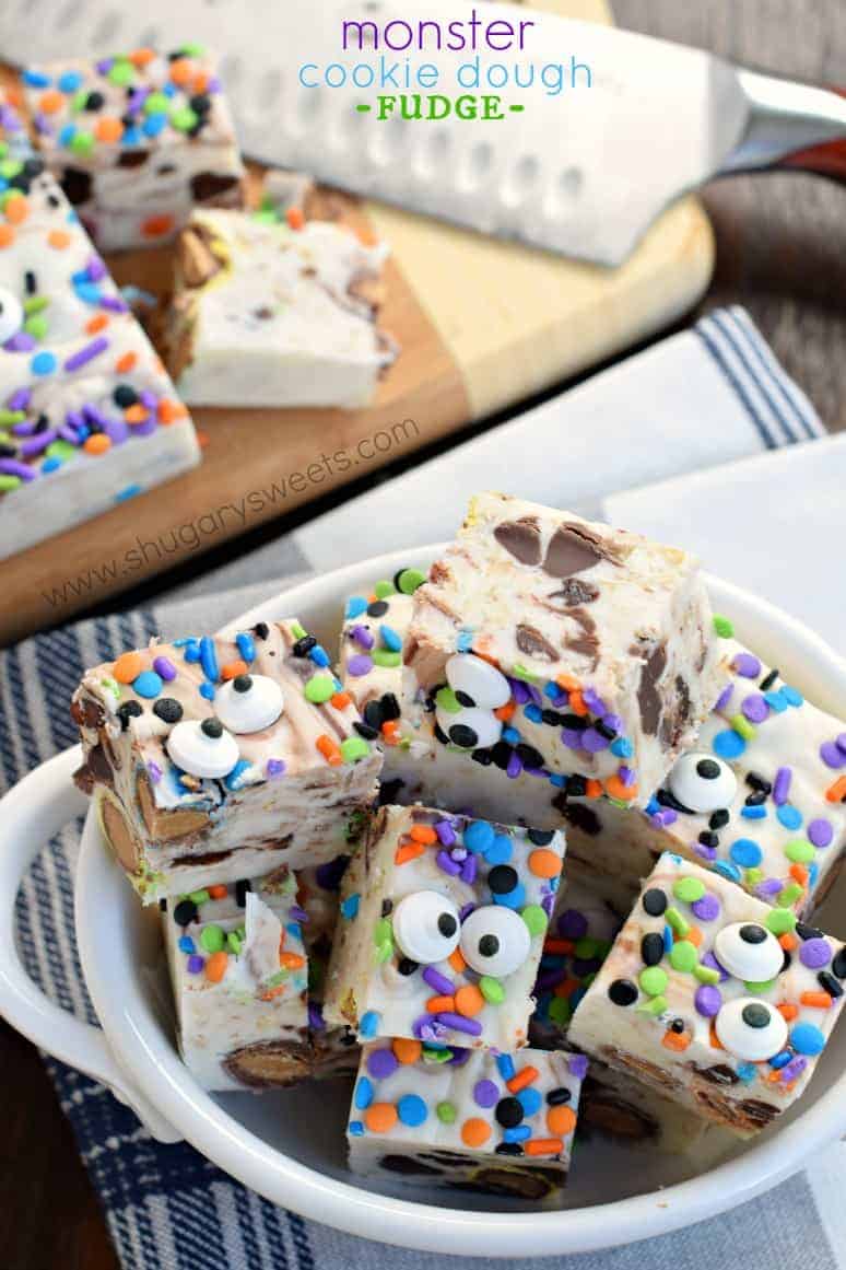 Monster cookie dough fudge pieces decorated with halloween sprinkles and candy eyes.
