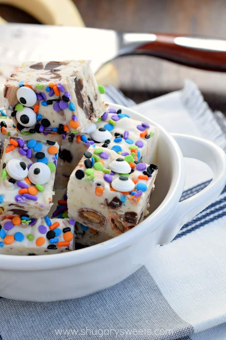 White bowl with pieces of monster cookie dough fudge.