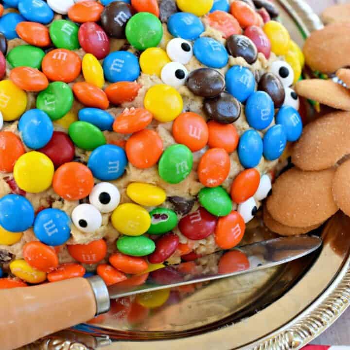 Cheese ball with monster cookie dough, and covered in M&M's and candy eyes.
