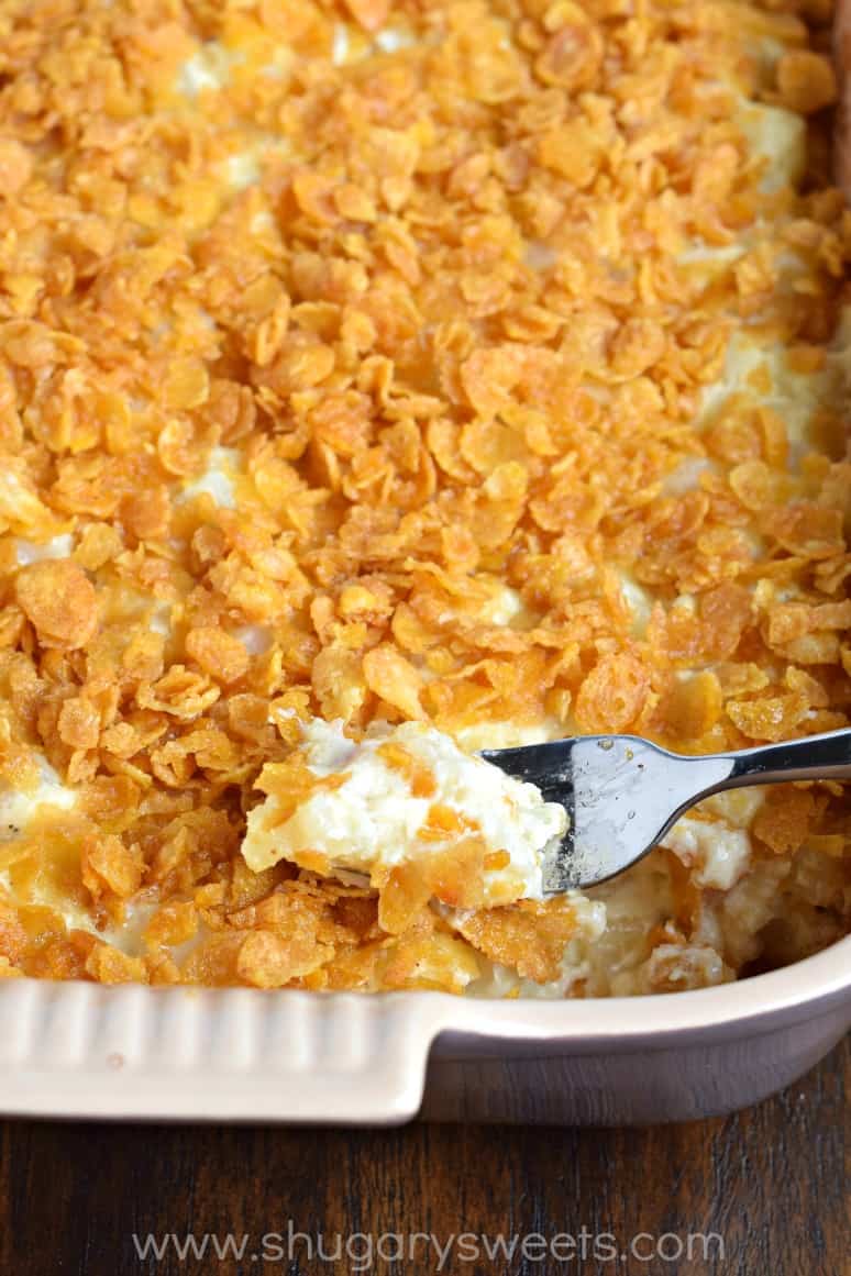 Hashbrown casserole with a fork taking a bite.