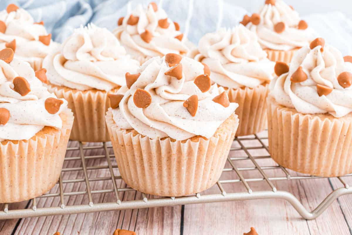 Cinnamon spice cupcakes on a wire cooling rack.