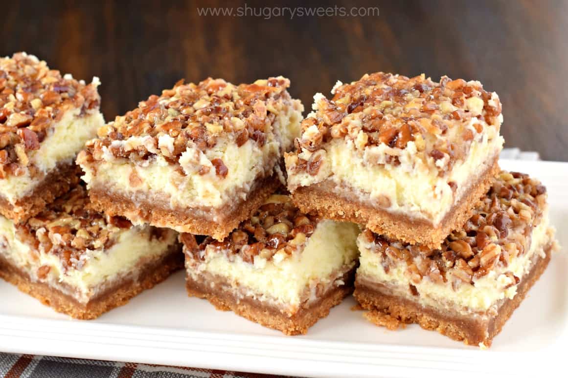 Pecan Pie Cheesecake bars on a white serving plate.