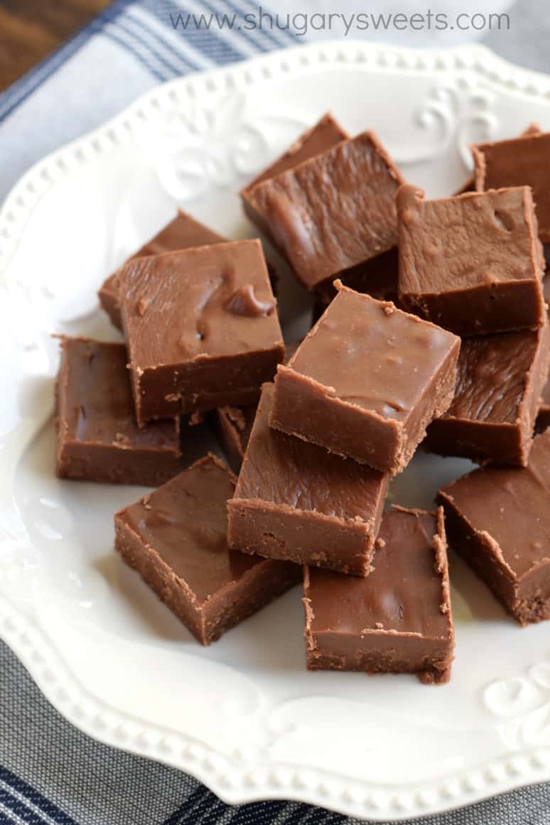 Pieces of chocolate fudge on a white plate.