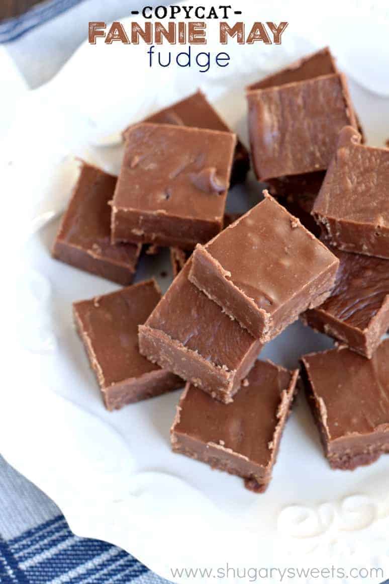 Fannie May Fudge A white plate topped with pieces of thick chocolate fudge.