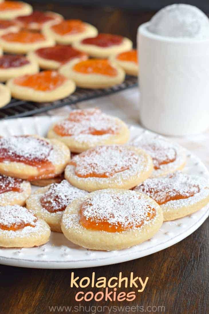 Kolachky cookies with powdered sugar on a white plate.