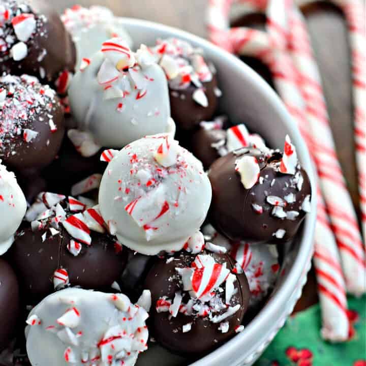 Peppermint truffles in a white bowl with candy canes.