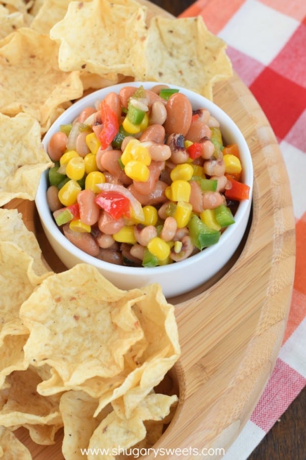 Texas caviar in a white bowl with tortilla chips.